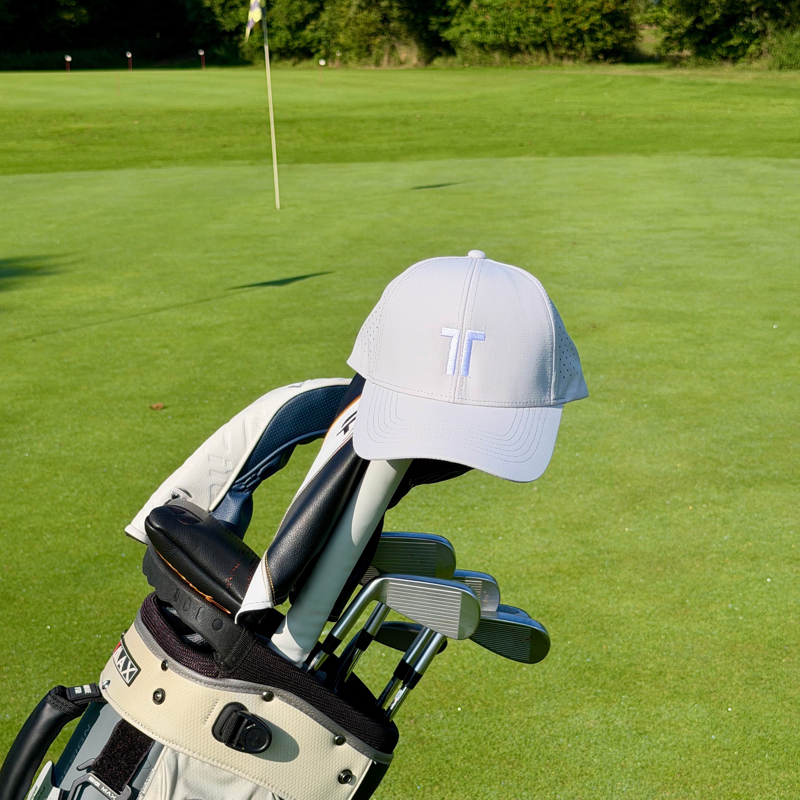THE CUTLINE Focus Cap in Weiß hängt am Golfbag